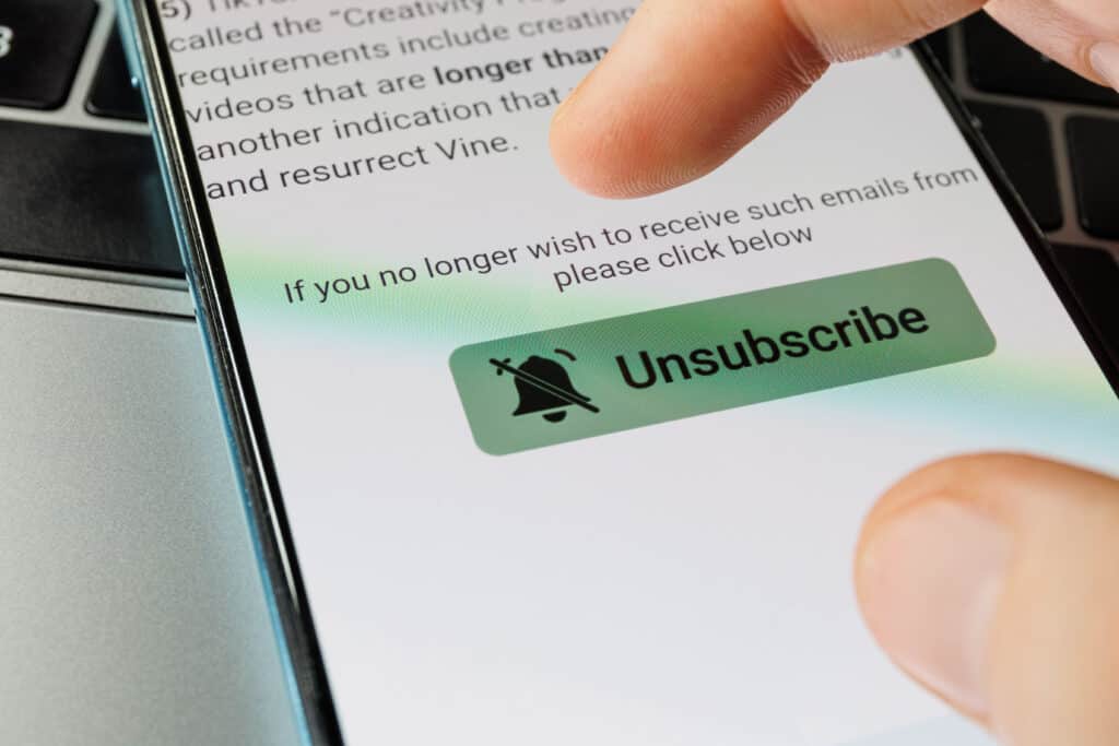 Unsubscribe button on smartphone. Unsubscribe of newsletters. High quality photo